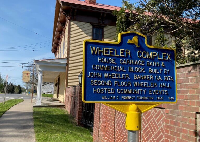 New York State historical marker for the Wheeler Complex.